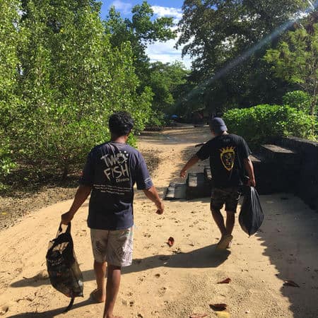 two fish beach clean Divemaster on the way to the beach