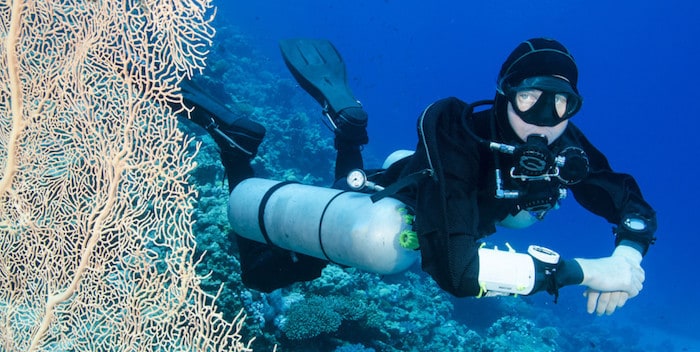 scuba diver with big fan coral in the ocean Sidemount Bali